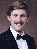 Sepia colored photo of John while he was in college getting his DVM.