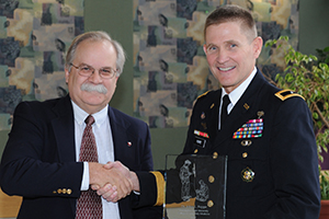 Dr. John L. Poppe receiving award with College of Veterinary Medicine Dean Bryan Slinker.