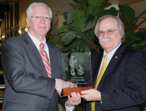 Dr. David Prieur receiving award with College of Veterinary Medicine Dean Bryan Slinker.