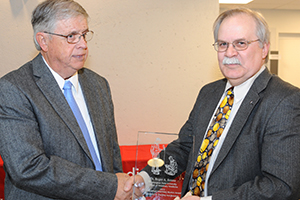 Dr. Roger A. Renne receiving award with College of Veterinary Medicine Dean Bryan Slinker.
