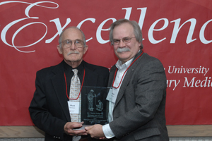 Dr. Charles Sedgwick receiving award with College of Veterinary Medicine Dean Bryan Slinker.