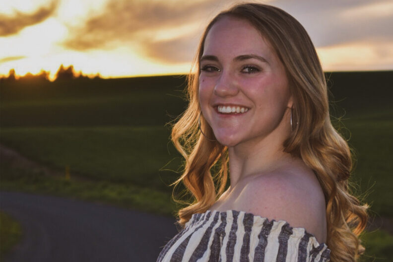 Olivia Willis at sunset with a field behind her.
