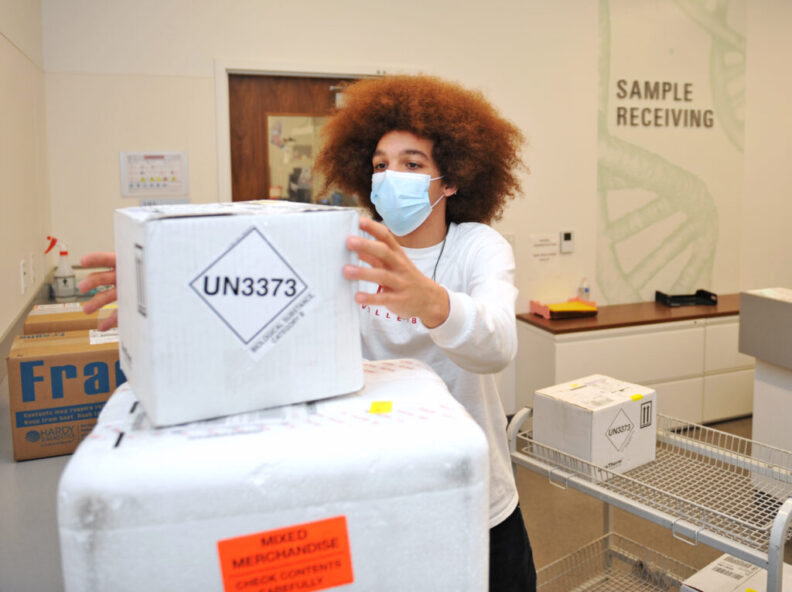 Joey McDonald intakes a shipment Monday at Sample and Receiving inside the Washington Animal Disease Diagnostic Laboratory.