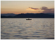 Row boat in the distance on a lake.