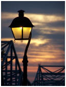 Street lamp on a pier at sunset.