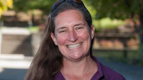 Dr. Huyvaert, smiling while outside on a summer day.