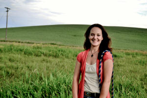 Kaylin Wells standing in green field.