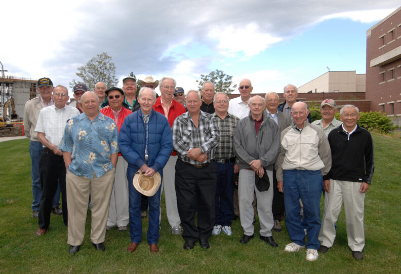 Group photo of those listed in the caption. They are standing on the grass in front of the Veterinary Teaching Hospital.