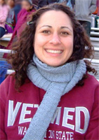 Gudrun at a WSU football game. She's wearing a Vetmed sweatshirt and large grey scarf.