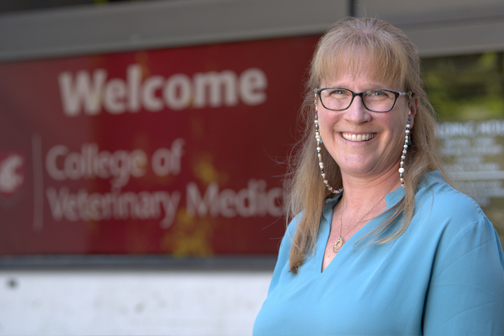 Dean Dori standing outside the entrance of Bustad Hall.