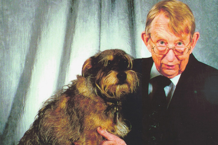 Studio portrait of Leo Bustad and his dog.