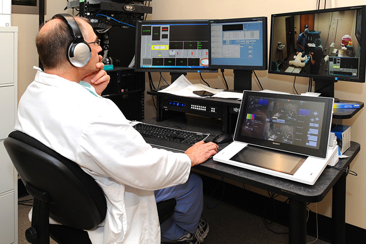 Dr. Robert Keegan monitors veterinary students as they work through a scenario in the WSU College of Veterinary Medicine’s Simulation-Based Education Program.