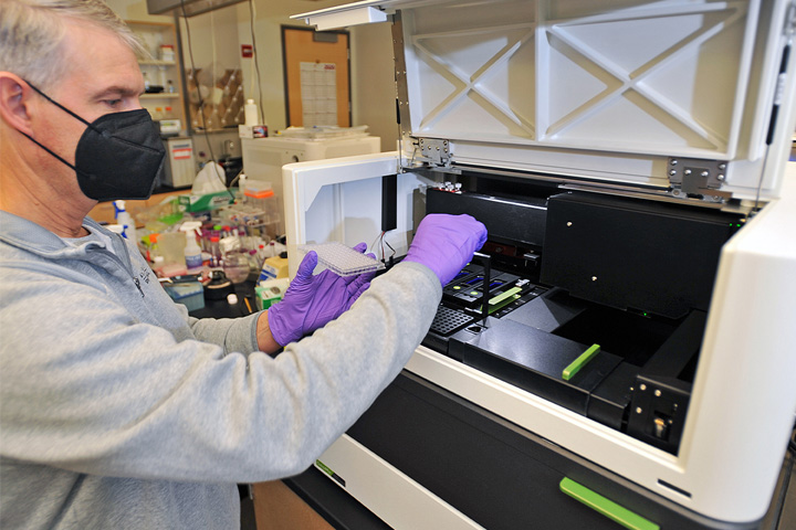 Derek Pouchnik, co-director of the Laboratory for Biotechnology and Bioanalysis, prepares tissue samples for the new GeoMx Digital Spatial Profiler inside WSU’s Biotechnology and Life Sciences Building.