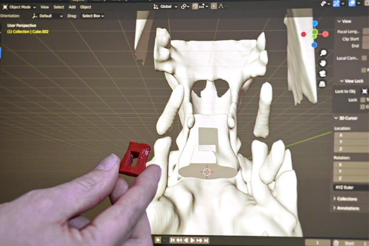 Dr. Tom Wilkinson holds a surgical guide he created using CT imaging data and a 3D printer at the WSU Veterinary Teaching Hospital.
