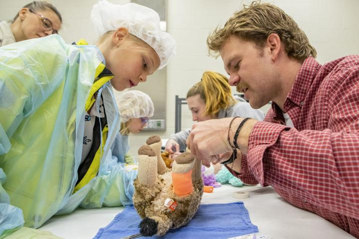 Cleopatra Schmidt, of Pullman, receives instruction on how to stitch up a wound from third year veterinary student, Andrew Boharski.
