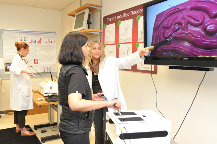 Dr. Boel Fransson instructing and demonstrating laparoscopic skills training.
