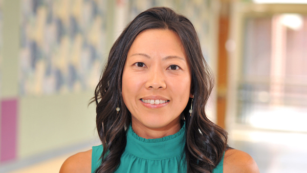 Annie Chen Allen in a lobby at the college.