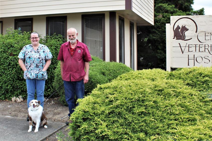 Ken Lindsay, right, stands with longtime Central Veterinary Hospital employee Michele McGuire. She has been bringing Liam, 8, to work with her since he was 2 days old.