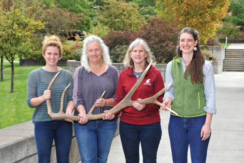 Group listed in caption holding a 6-point elk antler.
