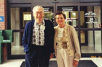 The Brimbles in their later years standing in front of the main entrance with the Veterinary Teaching Hospital.