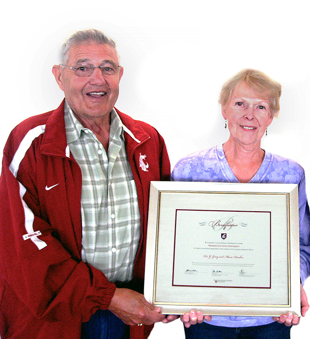 Gary and Marie holding their Benefactor plaque.