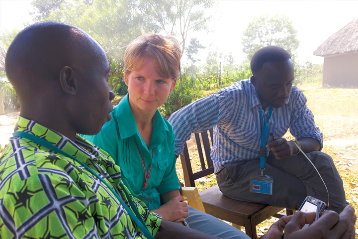 Veterinarian Victoria Olsen-Mikitowicz with two Kenyan men the population-based animal syndromic surveillance project.