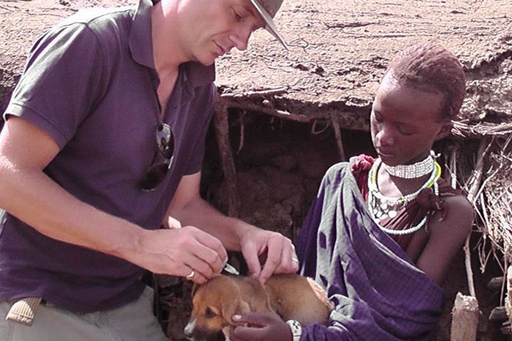 Dr. Lankester with a Maasai giving a puppy a rabies vaccination.