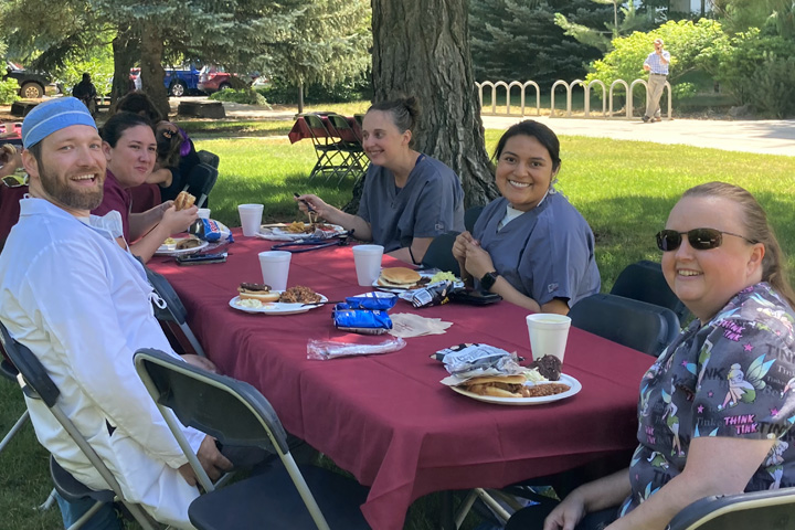 Veterinary Teaching Hospital staff enjoying a meal outside at the annual college bbq.