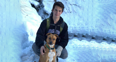 Jason hiking in the snow with his dog.