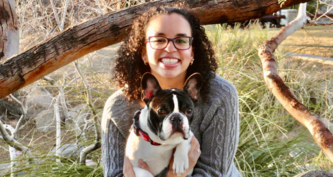 Haley in a grassy field with her French Bulldog.