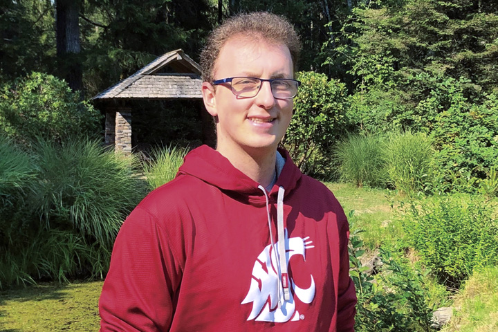 Seth, wearing a Cougar hoodie on a sunny day.