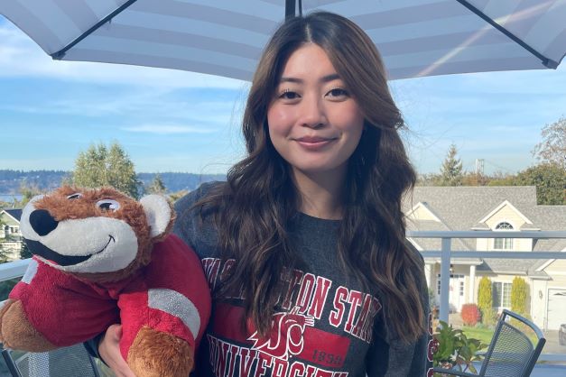 Student Nina Ly poses with a stuffed Butch.