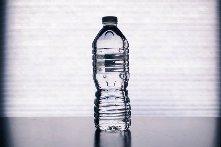Dramatic photo of a typical water bottle sitting on the table.