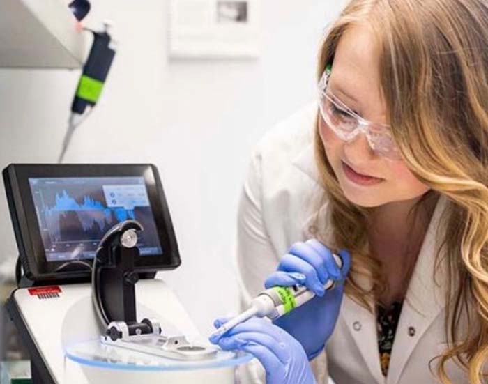Close up image of Emma working in a lab.
