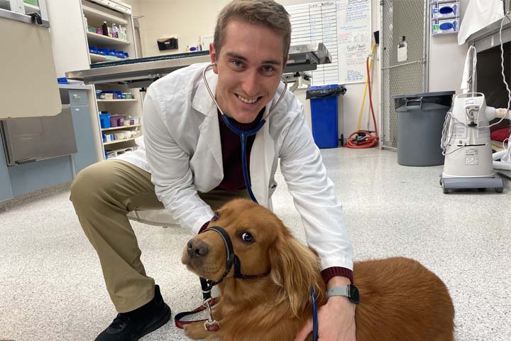 Troy with a Golden Retriever in the Veterinary Teaching Hospital.