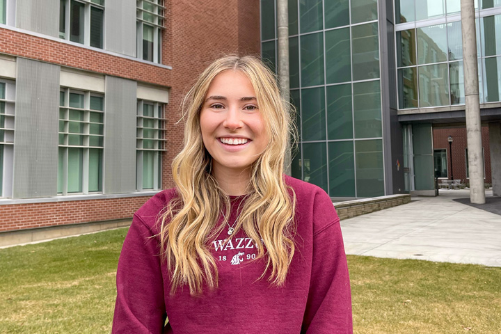 McKenna wearing Coug gear and standing outside VBR.