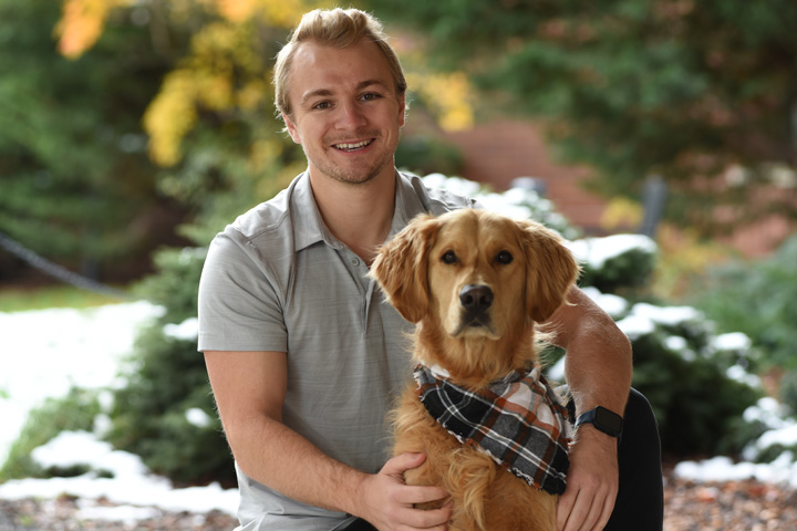 Chad with his dog, Huckleberry, a Golden Retriever.