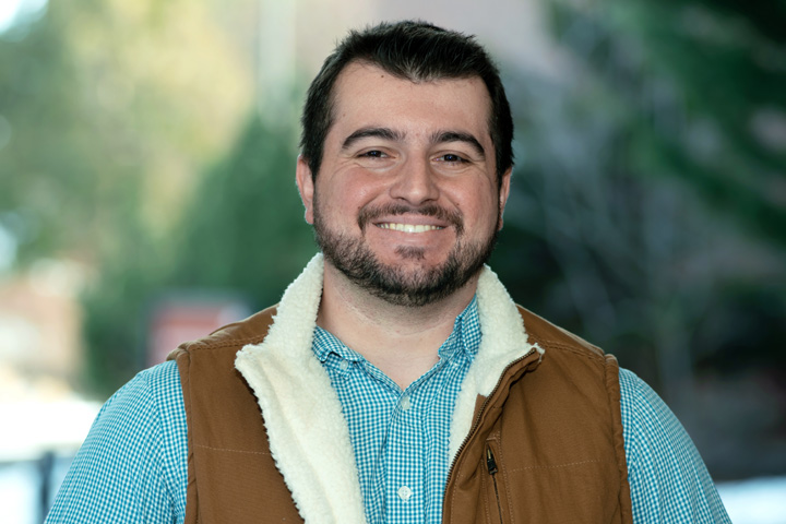 Dr. Figueiredo standing outside the Veterinary Teaching Hospital on a nice fall day.