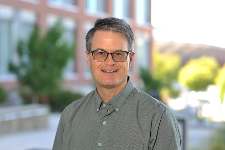 Dr. Mixter standing outside on a summer day.