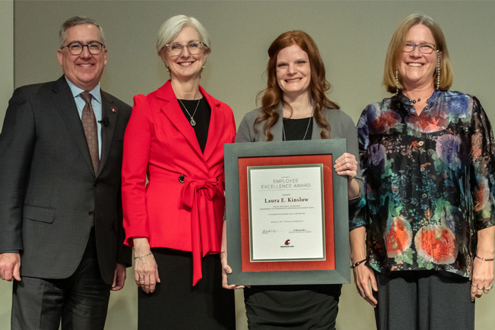 Laura Kinslow, second from right, poses for a photo with Dori Borjesson, right, Dean of the WSU College of Veterinary Medicine at Washington State University, WSU President Kirk Schulz, left, and WSU Provost Elizabeth Chilton, second from left, after Kinslow was honored with one of the President’s Employee Excellence Awards.