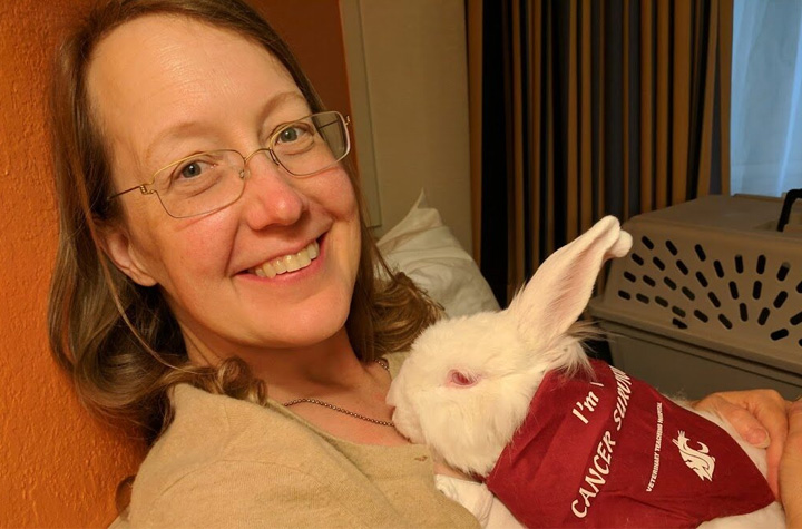 Paula holding Zsa Zsa who is wearing and I'm a Cancer Survivor scarf