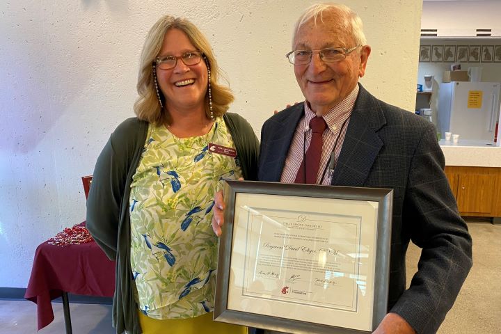 Veterinarian Dr. Raymond D. Ediger (’61 DVM) is awarded the Excellence in Practice Award by Dr. Dori Borjesson, dean of the College of Veterinary Medicine Friday afternoon inside the Mickelsen Lounge. Ediger is one of three alumni recognized for their achievements at college’s annual alumni awards.