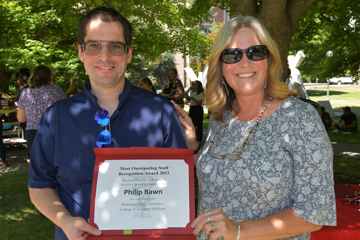 Philip Bawn receiving his award from Dean Dori Borjesson.