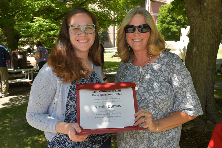 Nichole Dumas receiving her award from Dean Dori Borjesson.