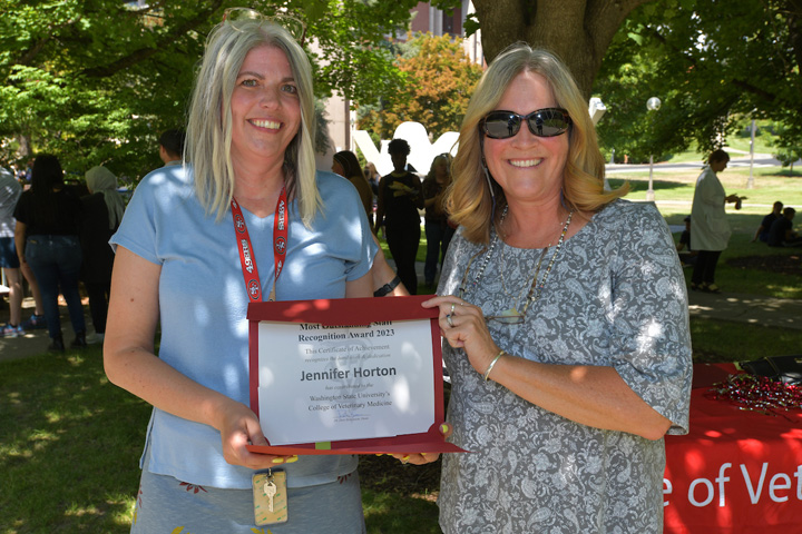 receiving her award from Dean Dori Borjesson.