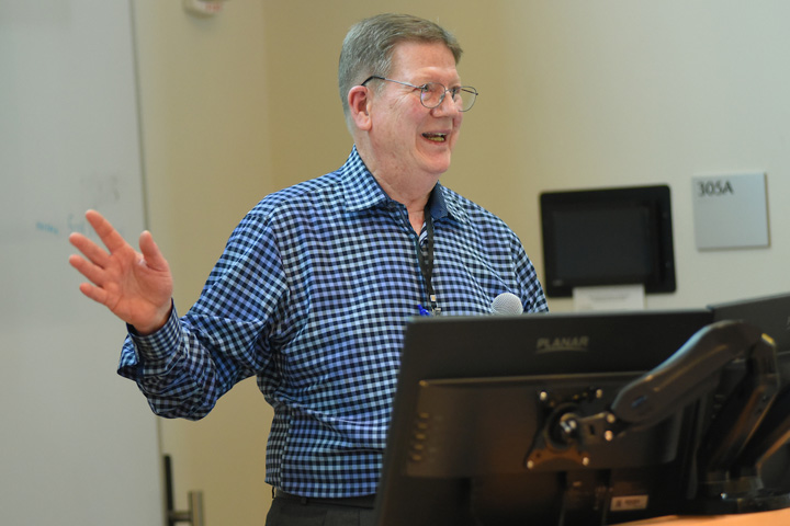 Dr. Krueger at the podium during his closing presentation at the symposium.