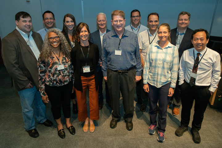 Group of speakers gathered around Dr. Krueger.