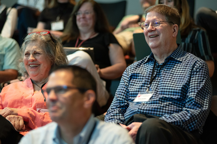 Dr. Krueger in the audience, laughing during one of the presentations.