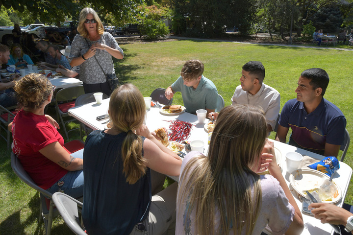 Dean Dori talking to a group of people at a table.