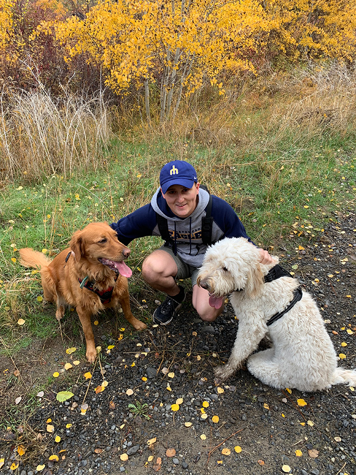 Jared with two dogs, a golden retriever and a goldendoodle.